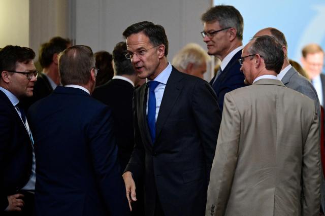 NATO Secretary General Mark Rutte (C) speaks to German Defence Minister Boris Pistorius after posing for a group photo prior to a weekly meeting of the German cabinet at the Defence Ministry in Berlin, Germany, on July 1, 2026. (Photo by John MACDOUGALL / AFP)