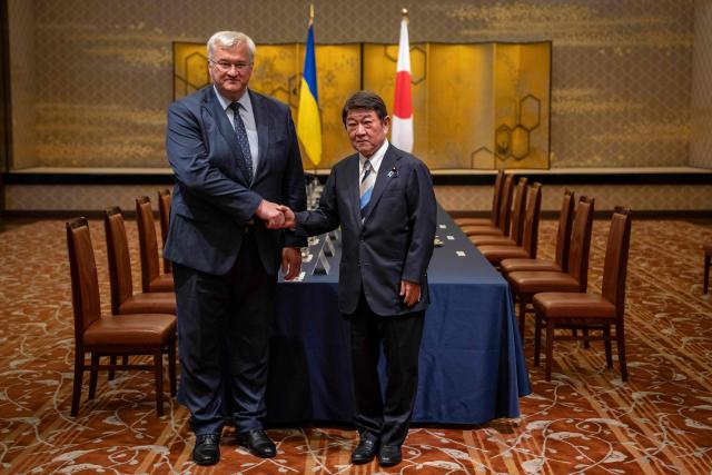 Japan's Foreign Minister Toshimitsu Motegi (R) and Ukraine's Foreign Affairs Minister Andriy Sybiga shake hands during their meeting at the Iikura Guest House in Tokyo on July 1, 2026. (Photo by Yuichi YAMAZAKI / AFP)