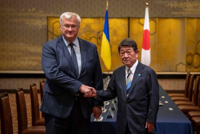 Japan's Foreign Minister Toshimitsu Motegi (R) and Ukraine's Foreign Affairs Minister Andriy Sybiga shake hands during their meeting at the Iikura Guest House in Tokyo on July 1, 2026. (Photo by Yuichi YAMAZAKI / AFP)