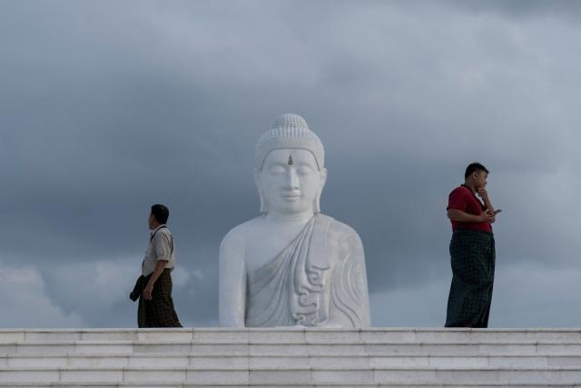 This photo taken on June 1, 2026 shows people visiting the marble Maravijaya Buddha statue in Naypyidaw. (Photo by Sai Aung MAIN / AFP)
