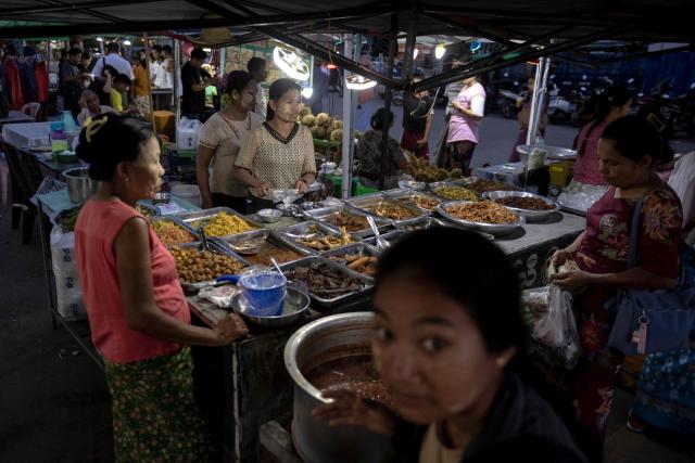 This photo taken on June 1, 2026 shows a vendor selling street food at a night market in Naypyidaw. (Photo by Sai Aung MAIN / AFP)
