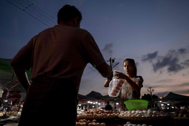 This photo taken on June 1, 2026 shows a vendor selling eggs at a night market in Naypyidaw. (Photo by Sai Aung MAIN / AFP)