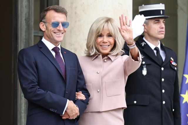 France's President Emmanuel Macron and his wife Brigitte Macron react as they wait to welcome Luxembourg's Grand Duke Guillaume and Luxembourg's Grand Duchess Stephanie at the Elysee Presidential Palace in Paris on July 1, 2026. (Photo by SIMON WOHLFAHRT / AFP)