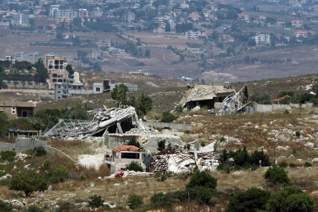 This picture taken from a position in the Upper Galilee in northern Israel shows destroyed buildings in a Lebanese village along the Israel-Lebanon border, on July 1, 2026. Israel's defence minister said on July 1 that Israeli forces would remain in self-proclaimed "security zones" established in Lebanon, Syria and Gaza, without any timeline for withdrawal. (Photo by Jack GUEZ / AFP) / 