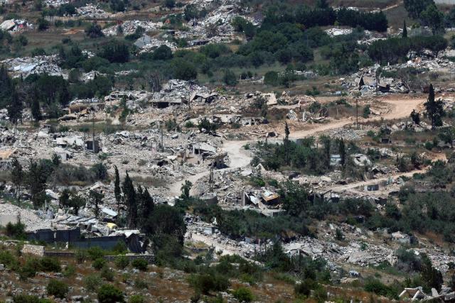This picture taken from a position in the Upper Galilee in northern Israel shows destroyed buildings in a Lebanese village along the Israel-Lebanon border, on July 1, 2026. Israel's defence minister said on July 1 that Israeli forces would remain in self-proclaimed "security zones" established in Lebanon, Syria and Gaza, without any timeline for withdrawal. (Photo by Jack GUEZ / AFP) / 