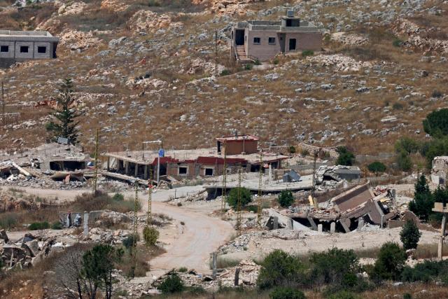 This picture taken from a position in the Upper Galilee in northern Israel shows destroyed buildings in a Lebanese village along the Israel-Lebanon border, on July 1, 2026. Israel's defence minister said on July 1 that Israeli forces would remain in self-proclaimed "security zones" established in Lebanon, Syria and Gaza, without any timeline for withdrawal. (Photo by Jack GUEZ / AFP) / 