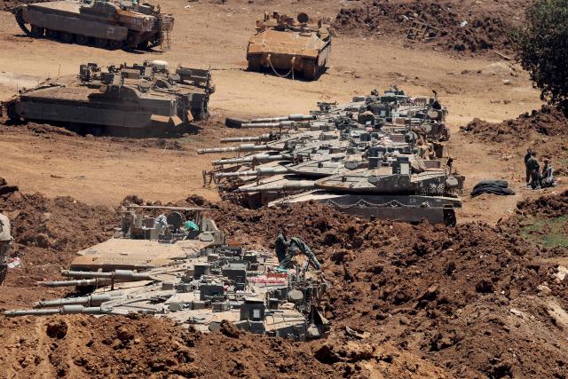 This picture taken from a position in the Upper Galilee in northern Israel shows Israeli army tanks positioned along the Israel-Lebanon border, on July 1, 2026. Israel's defence minister said on July 1 that Israeli forces would remain in self-proclaimed "security zones" established in Lebanon, Syria and Gaza, without any timeline for withdrawal. (Photo by Jack GUEZ / AFP) / 