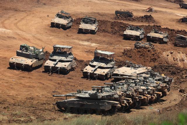 This picture taken from a position in the Upper Galilee in northern Israel shows Israeli army tanks positioned along the Israel-Lebanon border, on July 1, 2026. Israel's defence minister said on July 1 that Israeli forces would remain in self-proclaimed "security zones" established in Lebanon, Syria and Gaza, without any timeline for withdrawal. (Photo by Jack GUEZ / AFP) / 