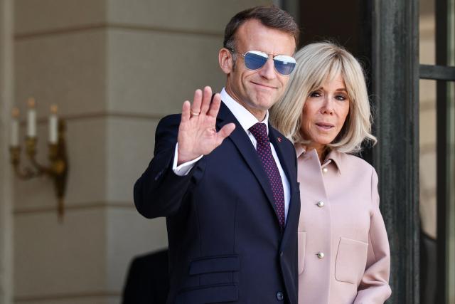 France's President Emmanuel Macron waves next to his wife Brigitte Macron after a meeting with Luxembourg's Grand Duke Guillaume and Luxembourg's Grand Duchess Stephanie at the Elysee Presidential Palace in Paris on July 1, 2026. (Photo by SIMON WOHLFAHRT / AFP)