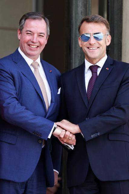 Luxembourg's Grand Duke Guillaume (L) and France's President Emmanuel Macron shakes hands as they pose after a meeting at the Elysee Presidential Palace in Paris on July 1, 2026. (Photo by SIMON WOHLFAHRT / AFP)