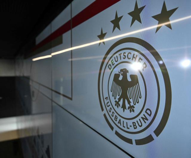 (FILES) This file photo taken on September 22, 2023 shows the logo of the German Football Federation (DFB) during a press conference at the DFB headquarters in Frankfurt, western Germany. Investigators raided Germany's football association headquarters and other locations across the country on July 1, 2026 as part of an investigation into corruption linked to the Euro 2024 tournament. The DFB confirmed that its headquarters in Frankfurt had been targeted. The case involves allegations that employees of German host cities were illegally invited to Euro matches and received tickets on favourable terms from the organisers, police and prosecutors said. (Photo by Kirill KUDRYAVTSEV / AFP)