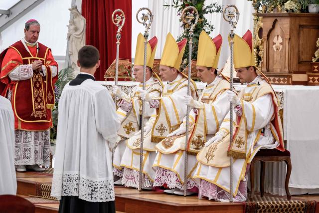(From L) The new traditionalist Catholic consacred bishops Swiss Pascal Schreiber, US' Michael Goldade, French Michel Poinsinet de Sivry and French Marc Hanappier seat next to Spanish born traditionalist Catholic Bishop of the Society of Saint Pius X (SSPX) Alfonso de Galarreta during the schismatic consecration of bishops by the traditionalist Catholic Society of Saint Pius X (SSPX) in Econe, western Switzerland, on July 1, 2026. The Society of Saint Pius X consecrated four new bishops on July 1, 2026, in defiance of Pope Leo XIV, who pleaded with the ultra-traditionalist breakaway group to turn back from what he called a "schismatic act" with Rome. (Photo by Fabrice COFFRINI / AFP)