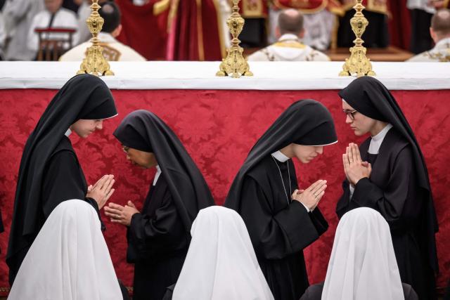 Nuns move during the communion during the schismatic consecration of bishops by the traditionalist Catholic Society of Saint Pius X (SSPX) in Econe, western Switzerland, on July 1, 2026. The Society of Saint Pius X consecrated four new bishops on July 1, 2026, in defiance of Pope Leo XIV, who pleaded with the ultra-traditionalist breakaway group to turn back from what he called a "schismatic act" with Rome. (Photo by Fabrice COFFRINI / AFP)