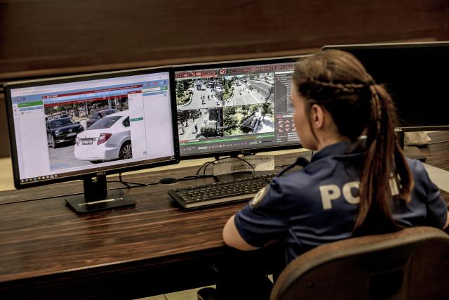 A Turkish police officer watches live CCTV images of the streets of Ankara from a monitoring centre as part of NATO security preparations, in Ankara on July 1, 2026. (Photo by Adem ALTAN / AFP)