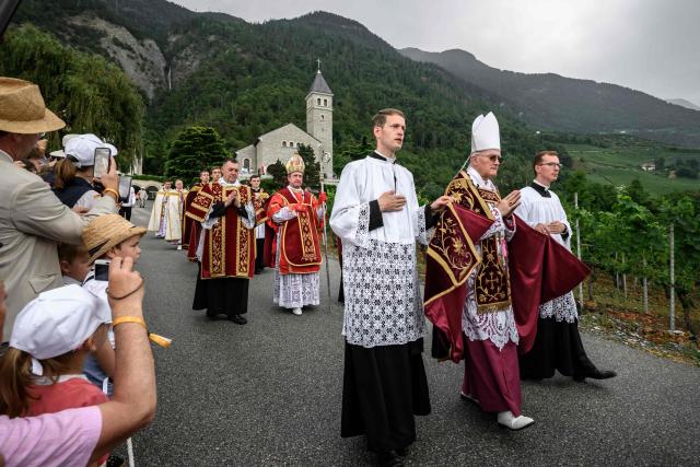 Swiss bishop Bernard Fellay (2nd R) and Spanish born bishop Alfonso de Galarreta (4th R) are marching in procession prior to the schismatic consecration of bishops by the traditionalist Catholic Society of Saint Pius X (SSPX) in Econe, western Switzerland, on July 1, 2026. The Society of Saint Pius X consecrated four new bishops on July 1, 2026, in defiance of Pope Leo XIV, who pleaded with the ultra-traditionalist breakaway group to turn back from what he called a "schismatic act" with Rome. (Photo by Fabrice COFFRINI / AFP)