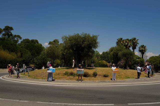 Activists from 'One Voice' hold pacards at the entrance of the Marineland in Antibes, Southeastern France, on July 01, 2026, to demand a sanctuary for the orcas Wikie and Keijo and the park's last twelve dolphins. (Photo by Valery HACHE / AFP)