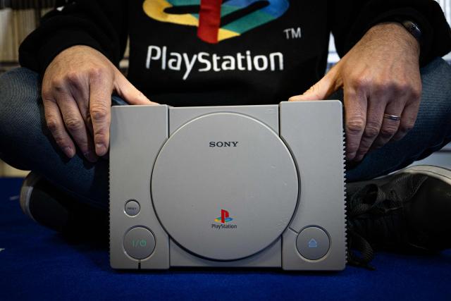 (FILES) French PlayStation' collector Cyril, poses with a PlayStaion 1, at his home in Vraiville, on November 20, 2024. Sony said on July 1, 2026 that it would stop releasing new video games for the PlayStation on disc in January 2028 following a shift in consumer preferences. "Following this date, new games will be available on PlayStation Store and at retailers in digital formats only," the company said on its official PlayStation blog. (Photo by LOU BENOIST / AFP)