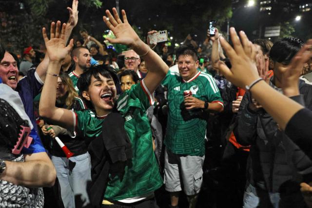 Mexican football fans celebrate Mexico’s victory over Ecuador after the FIFA World Cup 2026 match at the Angel of Independence monument in Mexico City on June 30, 2026. At least three people died during the mass celebrations in Mexico City to mark the national football team’s progress in the 2026 World Cup, the local government reported. (Photo by Claudia Rosel / AFP)