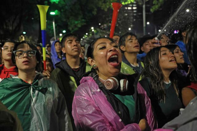 Mexican football fans react as they watch the FIFA World Cup 2026 match between Mexico and Ecuador at the Angel of Independence monument in Mexico City on June 30, 2026. At least three people died during the mass celebrations in Mexico City to mark the national football team’s progress in the 2026 World Cup, the local government reported. (Photo by Claudia Rosel / AFP)