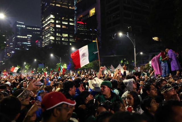 Mexican football fans celebrate Mexico’s victory over Ecuador after the FIFA World Cup 2026 match at the Angel of Independence monument in Mexico City on June 30, 2026. At least three people died during the mass celebrations in Mexico City to mark the national football team’s progress in the 2026 World Cup, the local government reported. (Photo by Claudia Rosel / AFP)