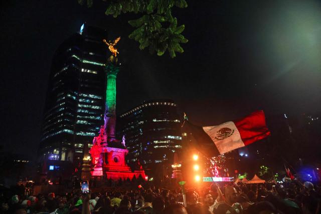 Mexican football fans celebrate Mexico’s victory over Ecuador after the FIFA World Cup 2026 match at the Angel of Independence monument in Mexico City on June 30, 2026. At least three people died during the mass celebrations in Mexico City to mark the national football team’s progress in the 2026 World Cup, the local government reported. (Photo by Claudia Rosel / AFP)