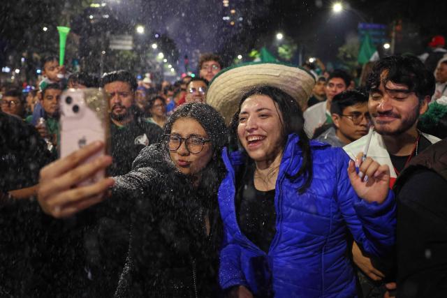 Mexican football fans celebrate Mexico’s victory over Ecuador after the FIFA World Cup 2026 match at the Angel of Independence monument in Mexico City on June 30, 2026. At least three people died during the mass celebrations in Mexico City to mark the national football team’s progress in the 2026 World Cup, the local government reported. (Photo by Claudia Rosel / AFP)