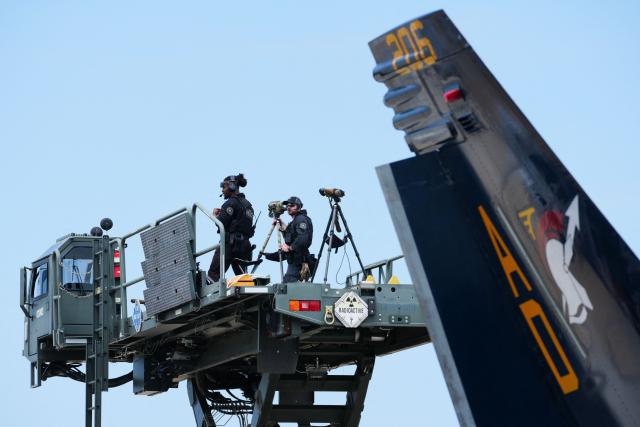 Members of the US Secret Service stand watch before Vice President JD Vance speaks during an event marking 250 years of the American military at Naval Air Station Oceana in Virginia Beach, Virginia, on July 1, 2026. (Photo by Ken Cedeno / POOL / AFP)