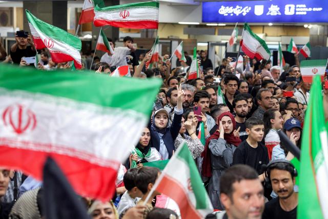 Iranian football fans gather at Tehran's Mehrabad International Airport to receive the men's national football team upon their return from the 2026 FIFA World Cup on July 1, 2026. (Photo by AFP)