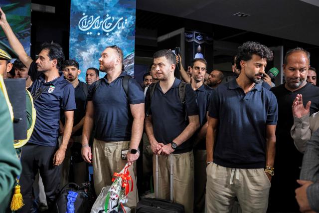 Members of Iran's men's national football team look onduring their reception at Tehran's Mehrabad International Airport on July 1, 2026 upon their return from the 2026 FIFA World Cup. (Photo by AFP)