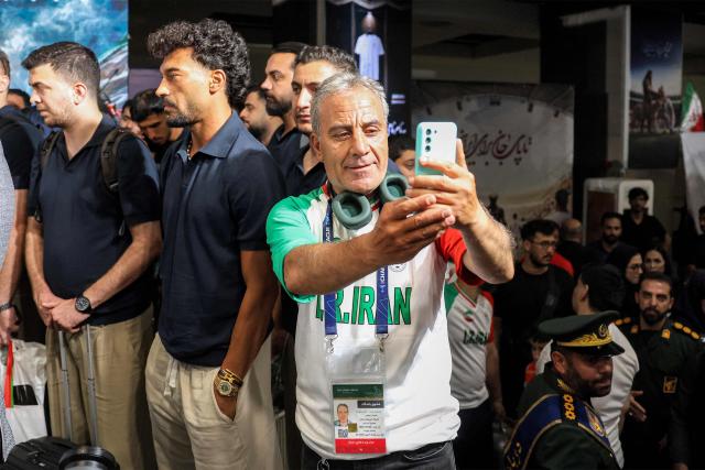 Members of Iran's men's national football team look onduring their reception at Tehran's Mehrabad International Airport on July 1, 2026 upon their return from the 2026 FIFA World Cup. (Photo by AFP)