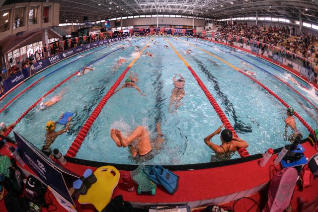 French athletes train before competing in finals during the French national swimming championships in Saint-Etienne, central France on July 1, 2026. (Photo by OLIVIER CHASSIGNOLE / AFP)