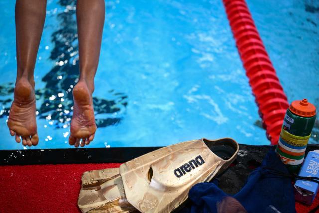 An athlete dives during a training session before competing in finals during the French national swimming championships in Saint-Etienne, central France on July 1, 2026. (Photo by OLIVIER CHASSIGNOLE / AFP)