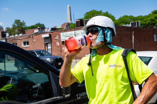 A construction worker takes a water break during a heat wave in Boston, Massachusetts on July 1, 2026. Tens of millions of Americans sweltered under furnace-like temperatures this week as central and eastern cities hunkered down for a heat wave set to last through the July 4 holiday weekend. Dozens of local temperature records could be broken, the National Weather Service (NWS) warned, with temperatures in many places to surpass 100 degrees Fahrenheit (38 degrees Celsius) and high humidity pushing the heat index as high as 115 degrees. (Photo by Joseph Prezioso / AFP)