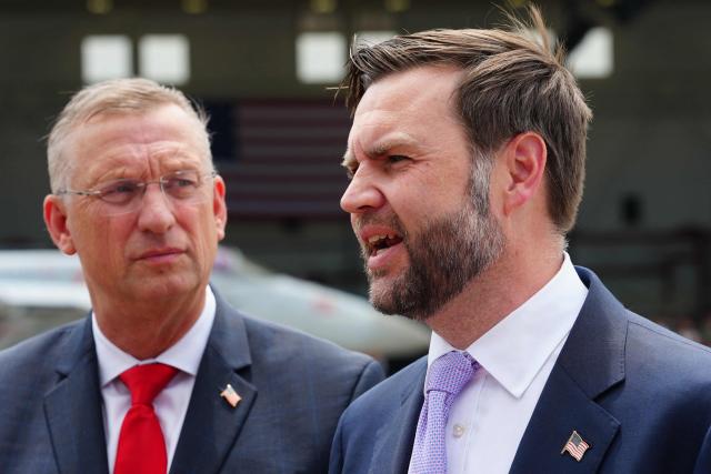 US Secretary for Veterans Affairs Doug Collins (L) listens as US Vice President JD Vance speaks to reporters following an event marking 250 years of the American military at Naval Air Station Oceana in Virginia Beach, Virginia, on July 1, 2026. (Photo by Ken Cedeno / POOL / AFP)