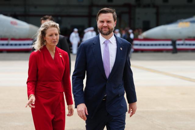 US Vice President JD Vance (R) walks with US Representative Jen Kiggans, Republican from Virginia, following an event marking 250 years of the American military at Naval Air Station Oceana in Virginia Beach, Virginia, on July 1, 2026. (Photo by Ken Cedeno / POOL / AFP)