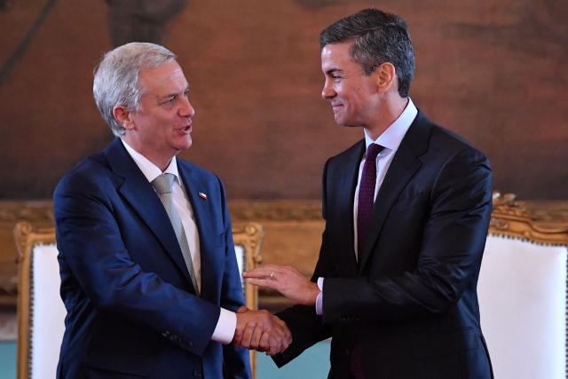 Chile's President Jose Antonio Kast (L) and Paraguay's President Santiago Pena shake hands during an agreement signing ceremony in Asuncion on July 1, 2026. (Photo by Daniel DUARTE / AFP)