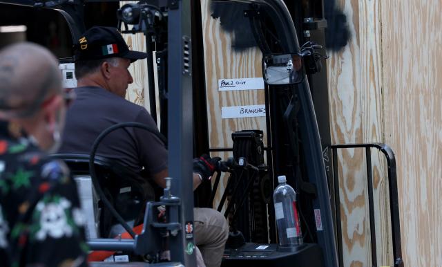 A worker loads in a crate reading "branches" outside Madison Square Garden in New York on July 1, 2026. Increasing signs point to a mega-bash for the A-list celebrity couple Taylor Swift and Travis Kelce at Madison Square Garden this week. Rumors have run rampant for weeks that the 36-year-old pop superstar and the three-time NFL Super Bowl winner, both 36, could wed at the storied sports arena, home to the New York Knicks, the newly crowned NBA champions. (Photo by TIMOTHY A. CLARY / AFP)
