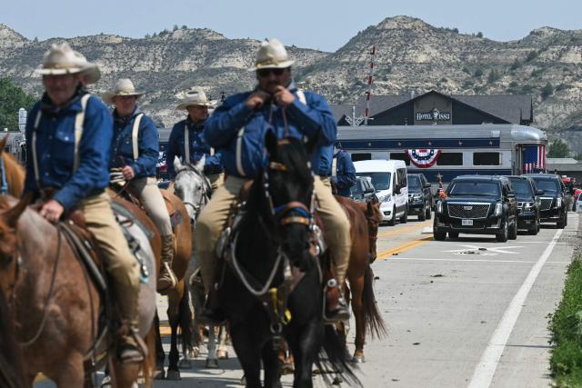 Rough Riders reenactors, portraying the 1st United States Volunteer Cavalry, ride horses ahead of US President Donald Trump's motorcade after President Trump arrived on the "Freedom250 train" on his way to attend the grand opening of the Theodore Roosevelt Presidential Library in Medora, North Dakota, July 1, 2026. . (Photo by SAUL LOEB / AFP)