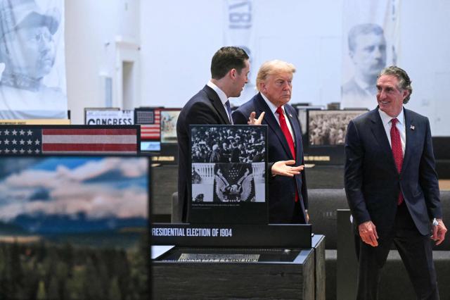 US President Donald Trump walks with Secretary of the Interior Doug Burgum (R) and Robbie Lauf (L), Executive Director of the Theodore Roosevelt Presidential Library, as he tours the Theodore Roosevelt Presidential Library in Medora, North Dakota, on July 1, 2026. . (Photo by SAUL LOEB / AFP)
