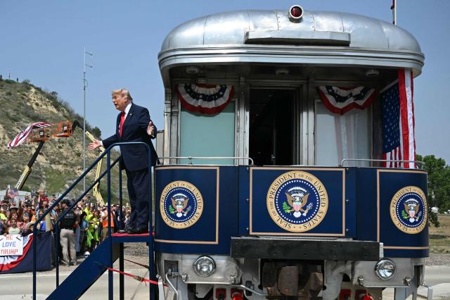 US President Donald Trump greets onlookers after arriving on the "Freedom250 train" on his way to attend the grand opening of the Theodore Roosevelt Presidential Library in Medora, North Dakota, July 1, 2026. . (Photo by SAUL LOEB / AFP)