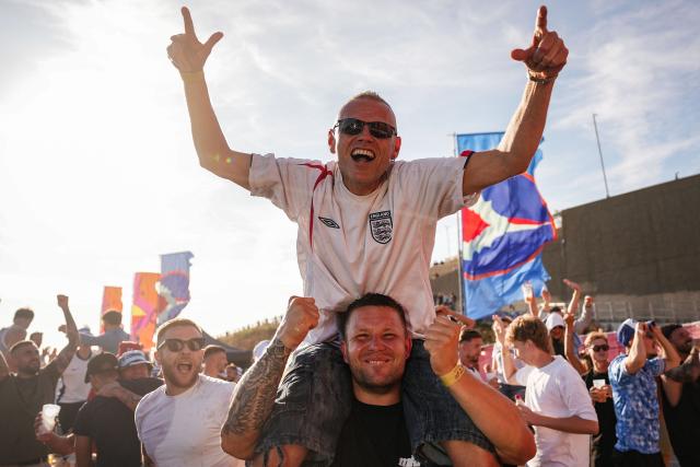 England supporters celebrate the team's victory after watching the 2026 World Cup round-of-32 football match between England and the Democratic Republic of Congo, at the 4TheFans Fan Park in Brighton, southern England on July 1, 2026. (Photo by CARLOS JASSO / AFP)