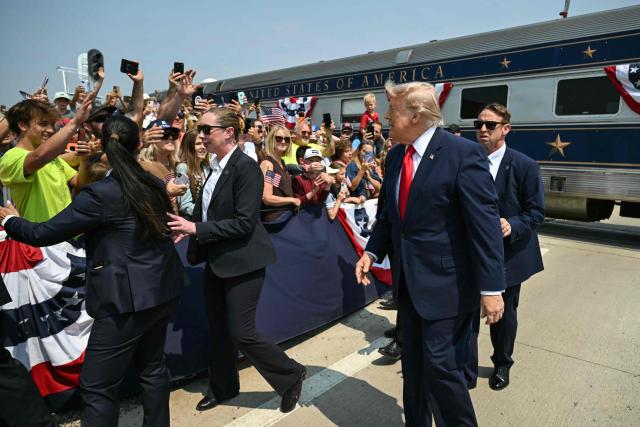 US President Donald Trump greets onlookers after arriving on the "Freedom250 train" on his way to attend the grand opening of the Theodore Roosevelt Presidential Library in Medora, North Dakota, July 1, 2026. . (Photo by SAUL LOEB / AFP)