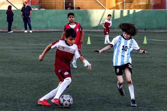 Boys play football at a pitch in the Amaari camp for Palestinian refugees, south of Ramallah in the occupied West Bank, on July 1, 2026. (Photo by Zain JAAFAR / AFP)