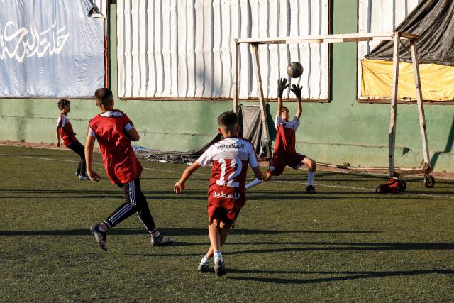 Boys play football at a pitch in the Amaari camp for Palestinian refugees, south of Ramallah in the occupied West Bank, on July 1, 2026. (Photo by Zain JAAFAR / AFP)