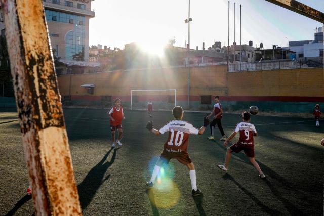 Boys play football at a pitch in the Amaari camp for Palestinian refugees, south of Ramallah in the occupied West Bank, on July 1, 2026. (Photo by Zain JAAFAR / AFP)