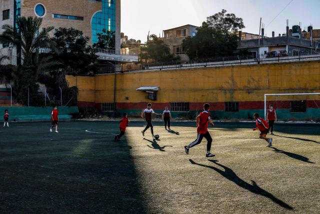Boys play football at a pitch in the Amaari camp for Palestinian refugees, south of Ramallah in the occupied West Bank, on July 1, 2026. (Photo by Zain JAAFAR / AFP)
