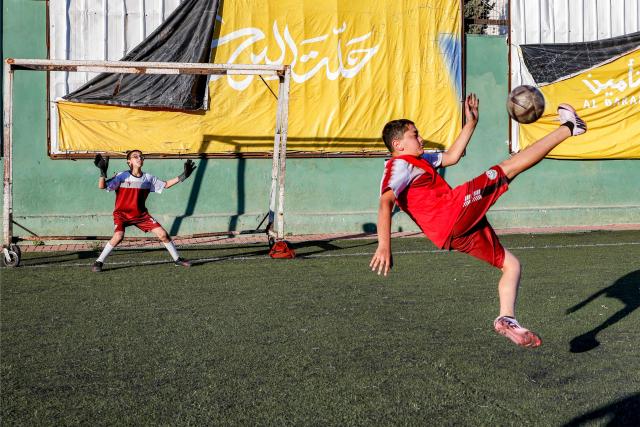 Boys play football at a pitch in the Amaari camp for Palestinian refugees, south of Ramallah in the occupied West Bank, on July 1, 2026. (Photo by Zain JAAFAR / AFP)