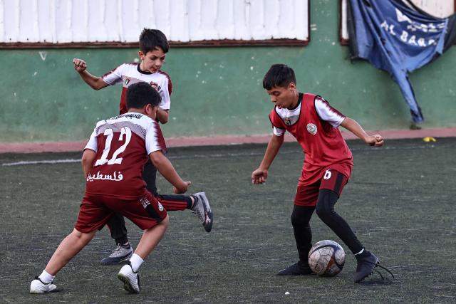Boys play football at a pitch in the Amaari camp for Palestinian refugees, south of Ramallah in the occupied West Bank, on July 1, 2026. (Photo by Zain JAAFAR / AFP)