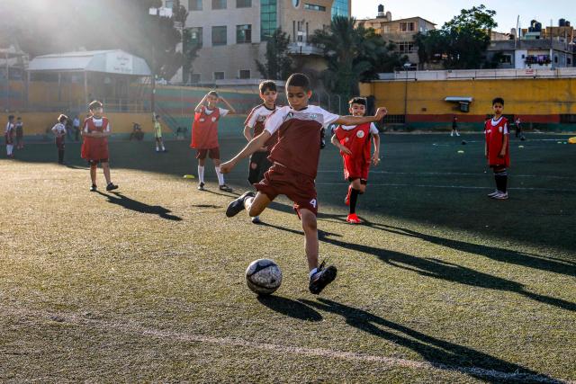 Boys play football at a pitch in the Amaari camp for Palestinian refugees, south of Ramallah in the occupied West Bank, on July 1, 2026. (Photo by Zain JAAFAR / AFP)