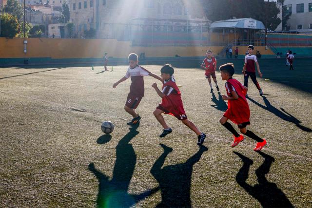 Boys play football at a pitch in the Amaari camp for Palestinian refugees, south of Ramallah in the occupied West Bank, on July 1, 2026. (Photo by Zain JAAFAR / AFP)